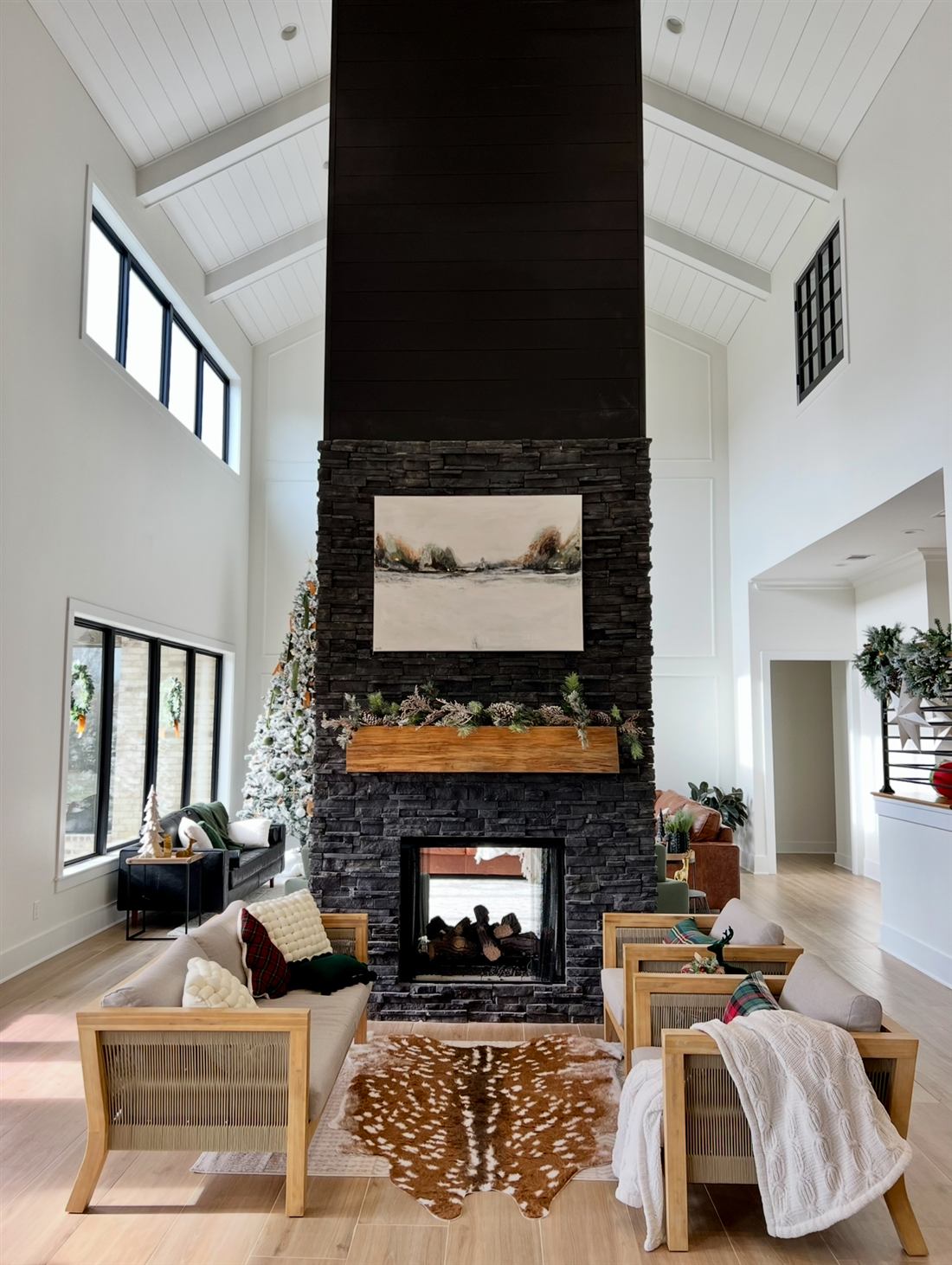 Custom home great room with vaulted shiplap ceiling and floor-to-ceiling stone fireplace, built in Northwest Louisiana